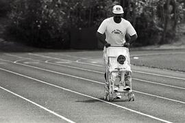 Harry Deo jogs with his son Krishan, 12 months, at Centennial Oval