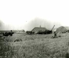 Threshing grain with large steam tractor (Colony Farm)