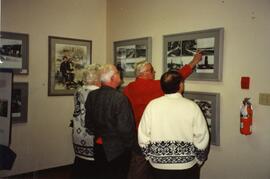 Workers looking at historic photographs of Fraser Mills