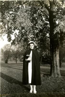Lillian Touzeau standing on Essondale grounds in a student nurse's uniform
