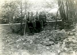 Family sitting on stone wall