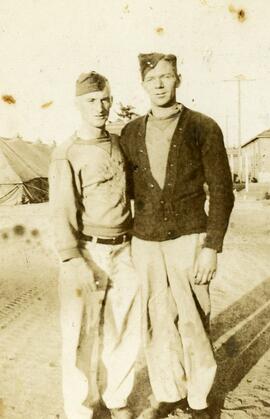 Two men in uniform standing in a camp