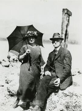 Fraser Mills, Couple at water's edge, woman holding an umbrella