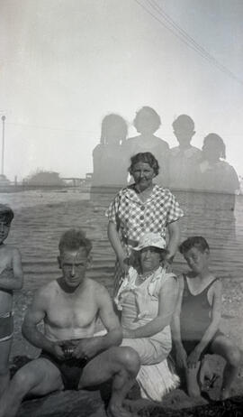 Man, two women and two children at a beach