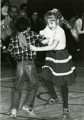Boy and girl square dancing
