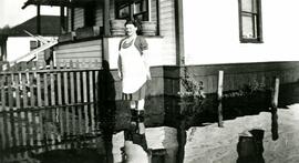 Mrs. Borghild Locken outside her house during the 1948 flood