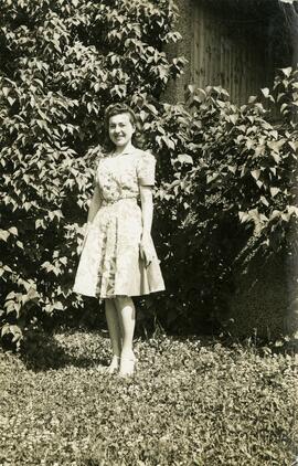 Mary Vasko standing in front of a bush