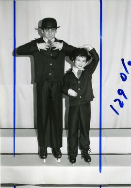 Two figure skaters posing in costume