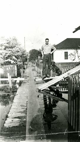 Hank Locken with his dog during the 1948 flood