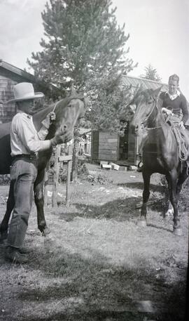 Leseme [sic] leading a horse and John Headridge riding a horse