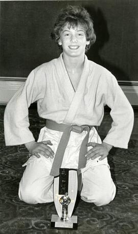 Boy posing with karate trophy