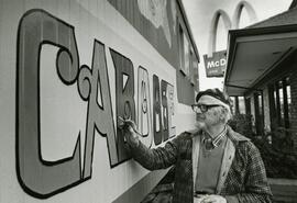 Man painting the McDonald's caboose
