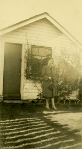 Woman in front of house