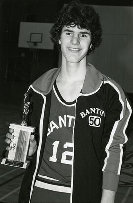Basketball player posing with MVP trophy