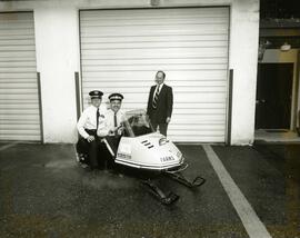 Parks patrol officers on a ski mobile