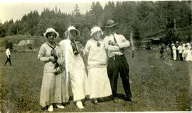 Three women and a man at a picnic