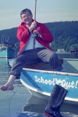 Retiring teacher/principal fishing off his boat, 'School's Out'