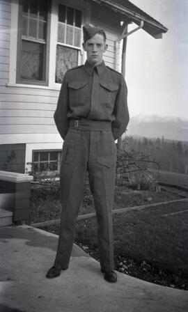Gordon Headridge in uniform in front of likely Essondale Cottage 118