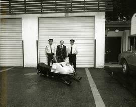 Parks patrol officers on a ski mobile