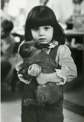 Little girl holding rabbit
