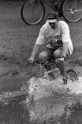Trevor Reed rides his mountain bike through a pond at Mundy Park