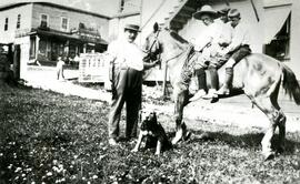 Children on a horse in front of Proulx Store
