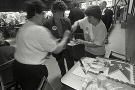 Employees cut birthday cake for customers at K-mart's 30th birthday at Westwood Mall