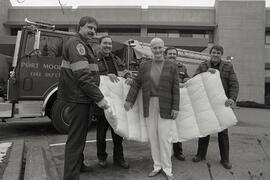 Port Moody Firefighters make presentation to Eagle Ridge Hospital of funds for mattresses