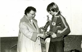 Boy accepts hockey trophy