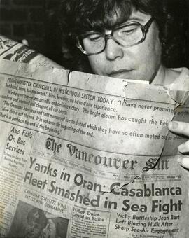 Woman reads old issue of the Vancouver Sun
