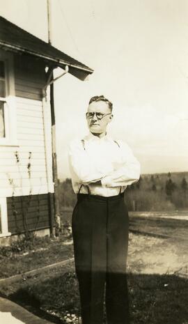 William Headridge standing in front of likely Essondale Cottage 118