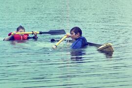 Kevin Hampton and Jeremy Woodsworth struggle to paddle their swamped canoe ashore at Lafarge Lake