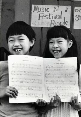 Kids holding sheet music