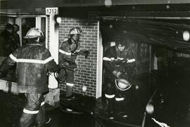 Firefighters in a burnt home