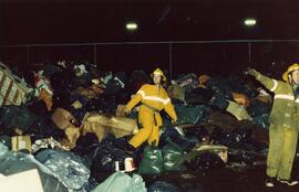Firefighters in a garbage dump