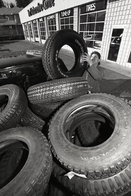 Mike Guratovich, owner of the FireStone Tire Automotive Centre at 1124 Falcon Ave. unloading new shipment of all seasons