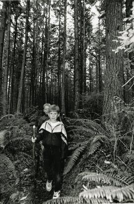 Braden Beaver, 7, (front), and Paul Scott, 8, hiking thru the tall trees.