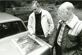 Jim Sheppard and Byron Swinney look over an aerial photo of the 230 acre site they want to develop into a golf course in PoCo.