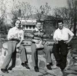 Men sitting by a well