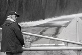 Pit River rd, East of Baily Bridge closed due to flooding. Public Works forman Blane Anderson installs signals on Bailey Bridge barriers.