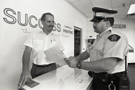 Mike Thede and PC Mike Galbraith discuss fraud prevention, for Chambernewsletter