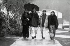 Rainy day tour. 4 students from George Pearkes school. Deanna, Brooke, Mike and Nina under umbrellas