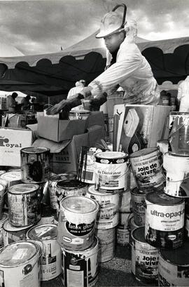 Leon Barrett sorts through all the paint cans, so that it can be recycled