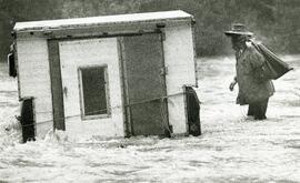 With belongings from his truck Mike starts off to complete his crossing of the Coquitlam River Thursday evening just prior to the dam opening up