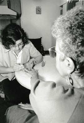April Stannell, home support worker, doing nails of Evelyn McAdams.