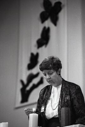 Barb Patterson lights a candle of Memories at annual candlelight memorial service for dead children, sponsored by Compassionate Friends, at Como Lake United Church