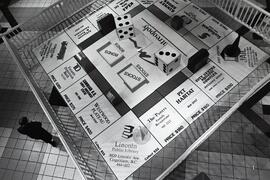Shoppers stroll by giant monopoly board in centre court of Coquitlam Centre