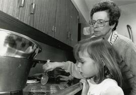 Julie Wright, 5, gets a hand from her grandmothers friend Vivian Wilson during chocolate making session at Dogwood Pavilion