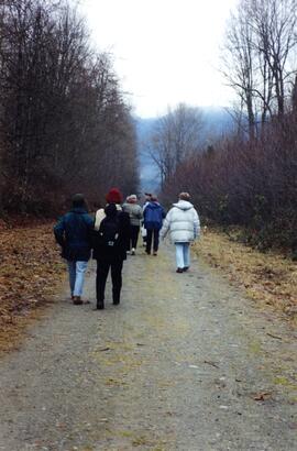 Society members walking on a path the Riverview grounds