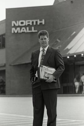 Salesman in front of Coquitlam Centre